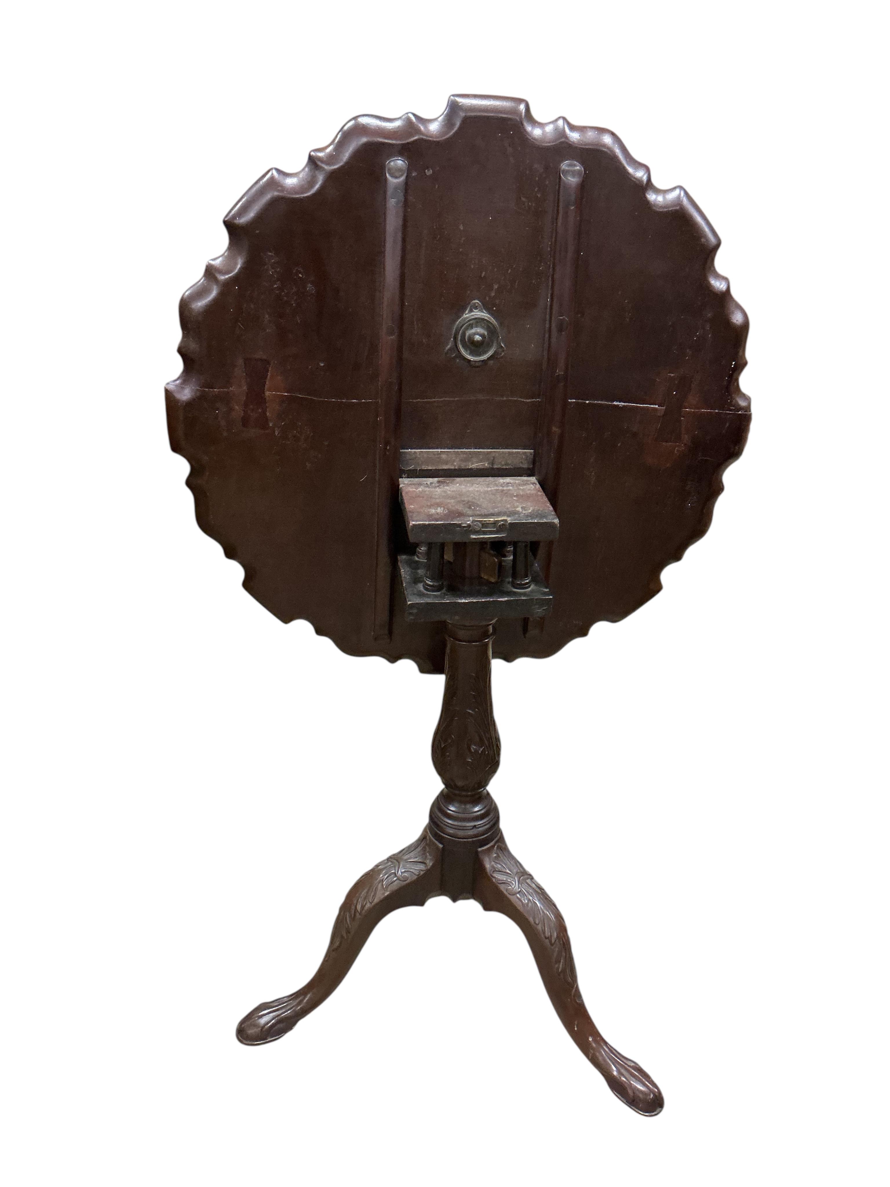 A George III circular mahogany piecrust tilt top bird cage tripod tea table, diameter 64cm, height 71cm (repair to top)